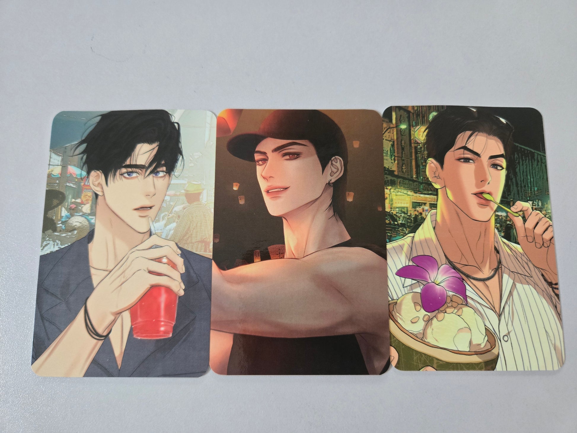 Three illustrated cards featuring Jitae, Jaekyung and Jaeshin