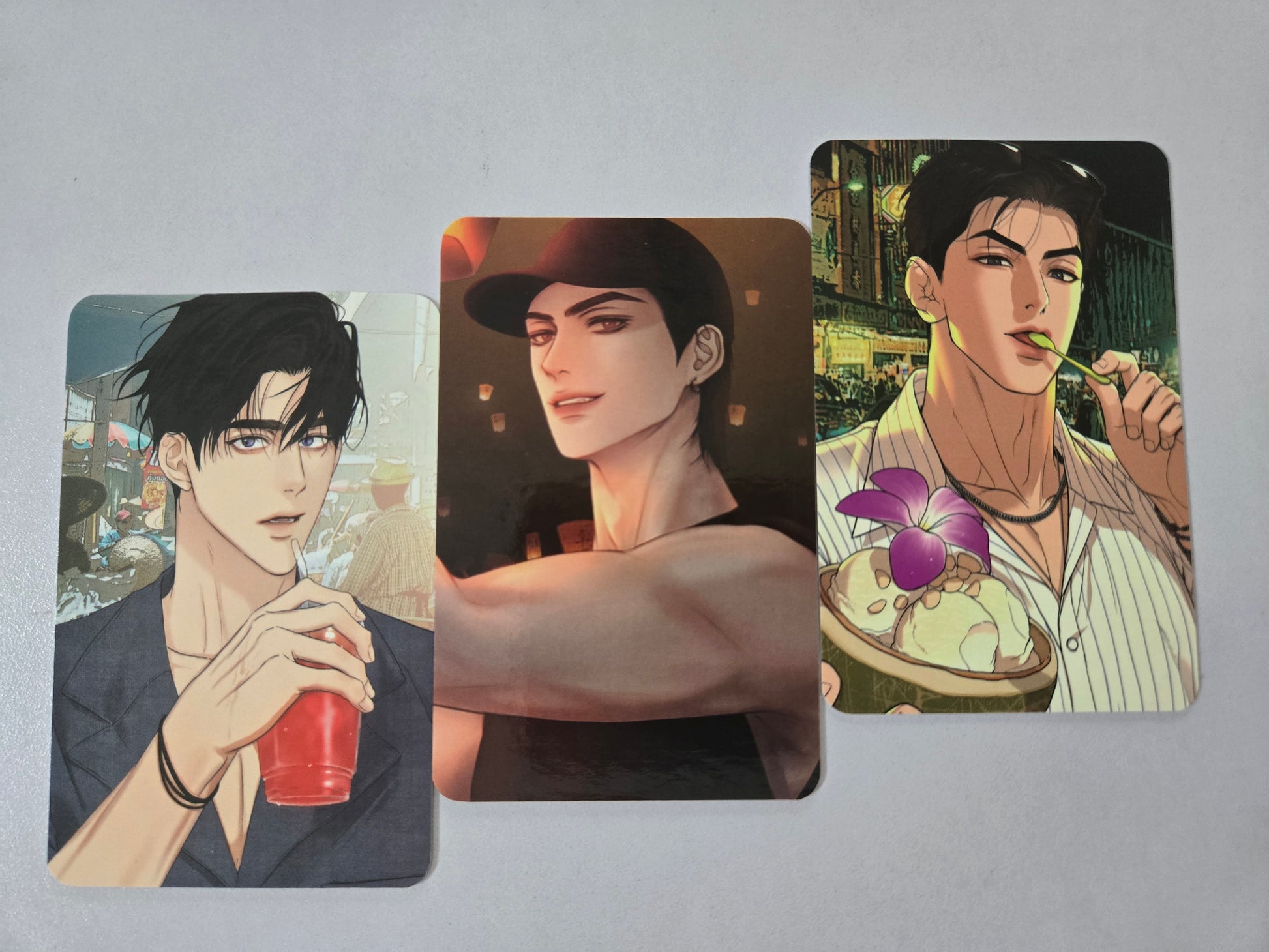 Three illustrated cards featuring Joo Jaekyung, Jaeshin and Jitae