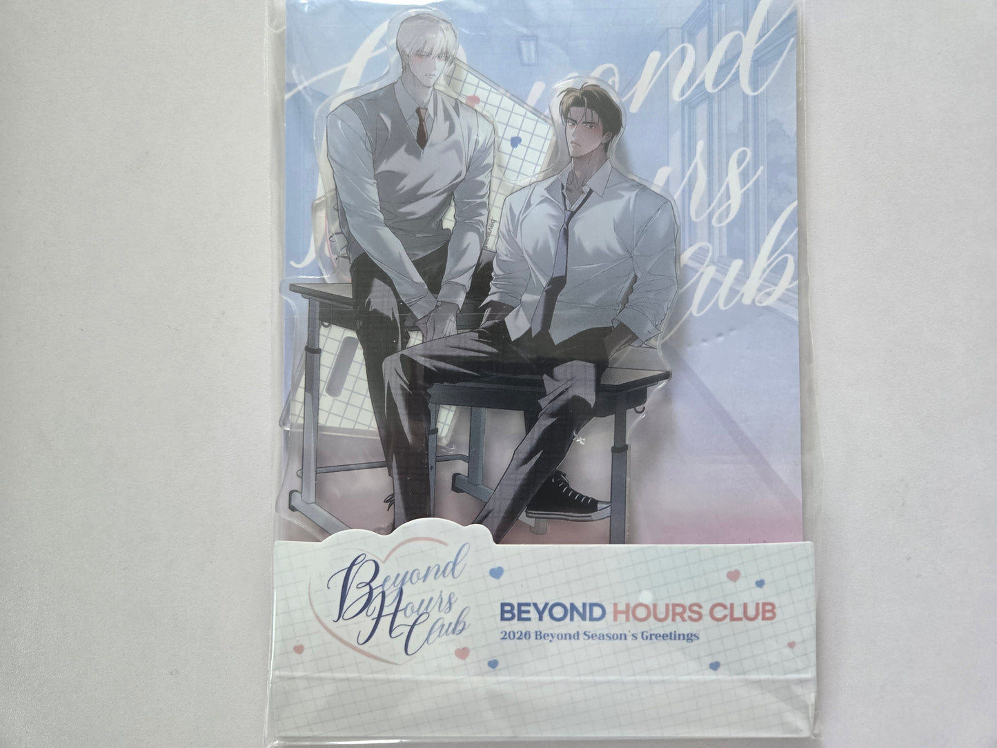 Beyond Hours Club acrylic stand with text 'BEYOND HOURS CLUB' and '2026 Beyond Hours Greetings' on packaging