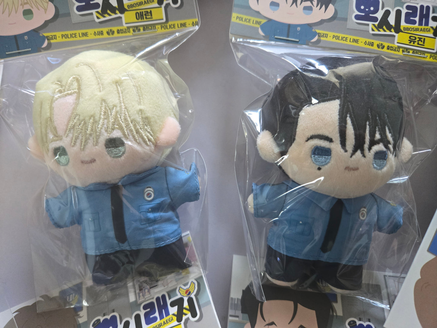 Flashlight plush dolls in retail packaging, featuring Aaron and Yujin