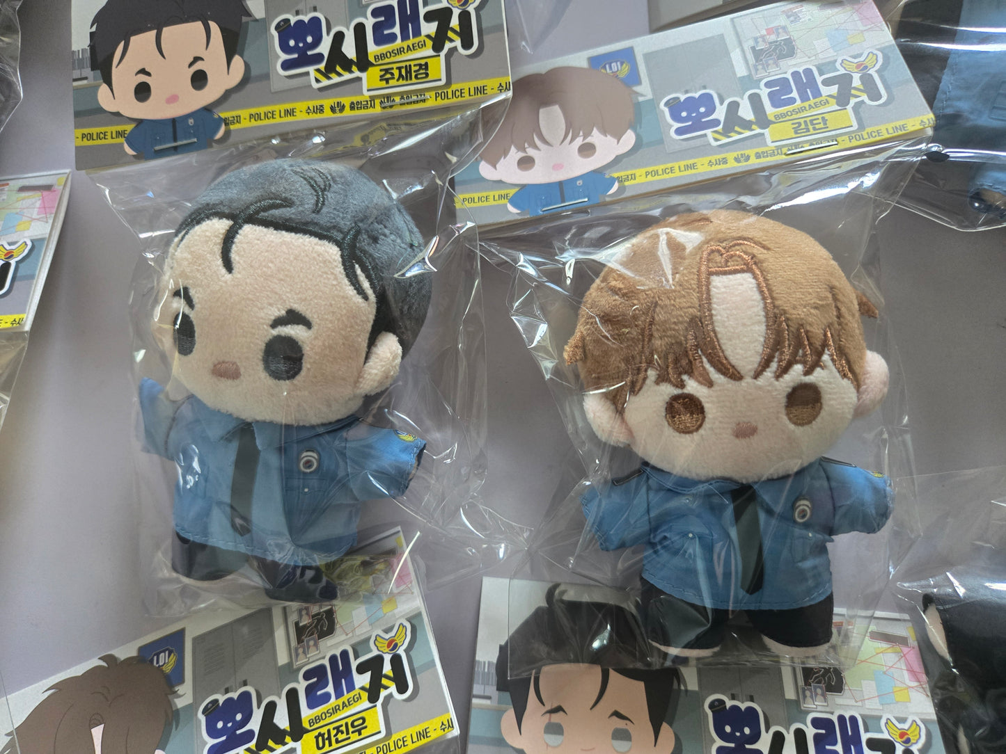 Jinx plush dolls in retail packaging, featuring Kim Dan and Jaekyung 