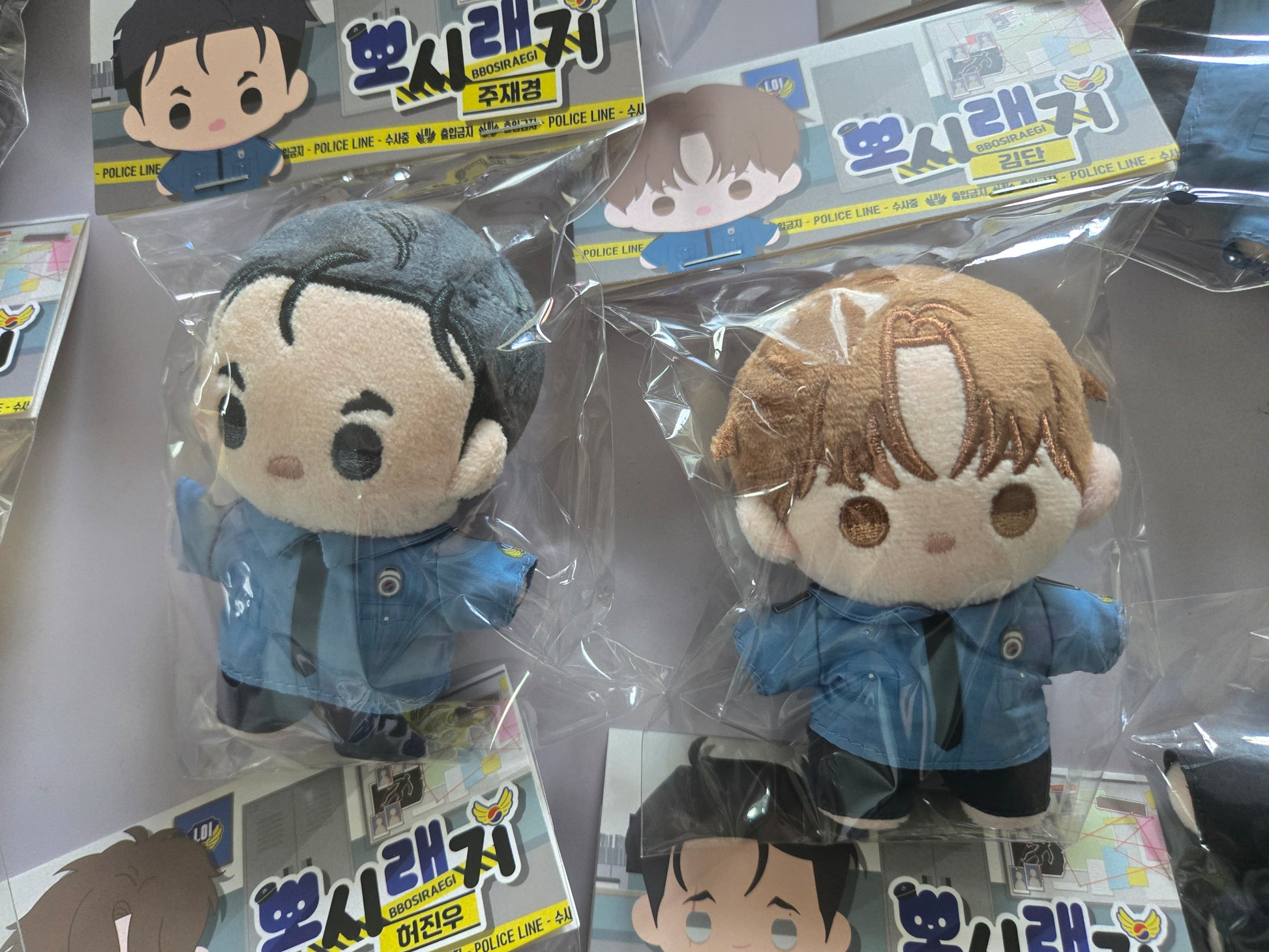 Jinx plush dolls in retail packaging, featuring Kim Dan and Jaekyung 