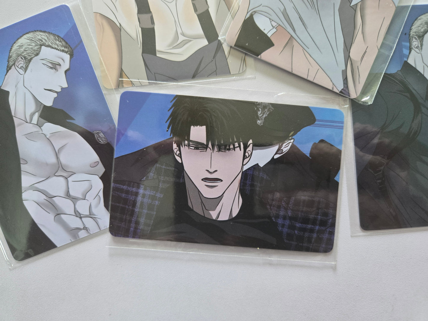 dark-haired male character in a plaid jacket with a police office at the back