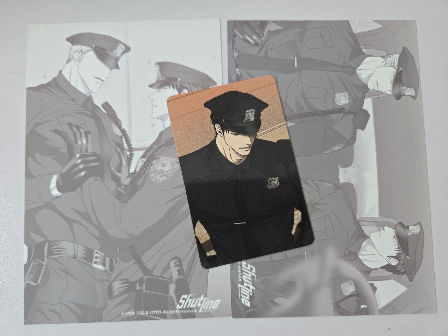 Shin in a police uniform on a gray background with illustrations.