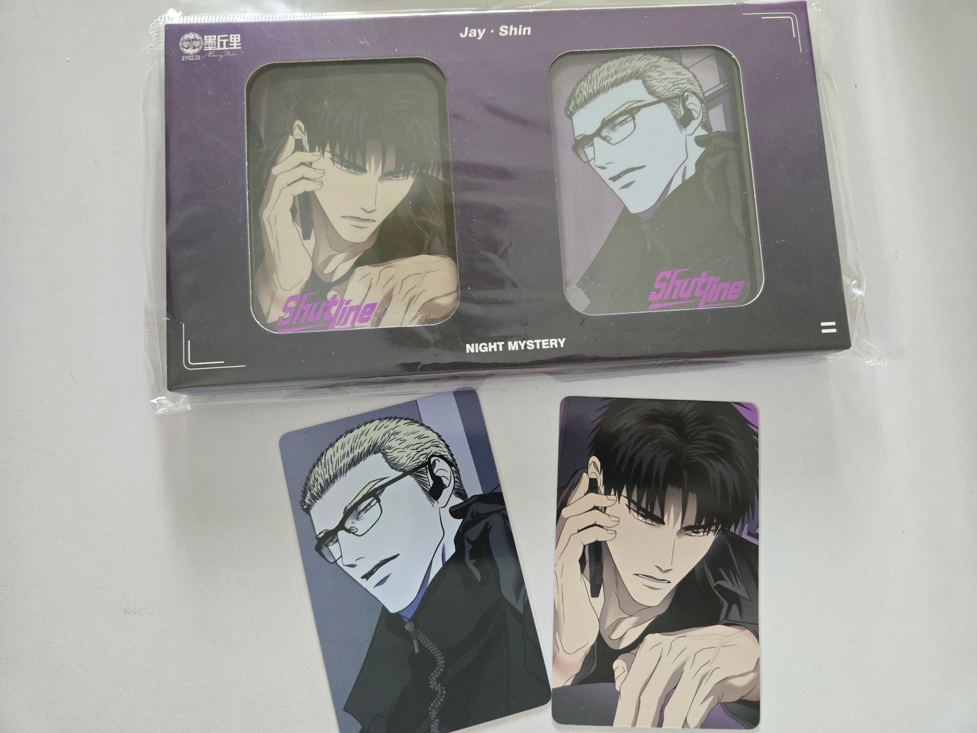 Packaged product with illustrations of Shutline characters and a card featuring one character on a white background.